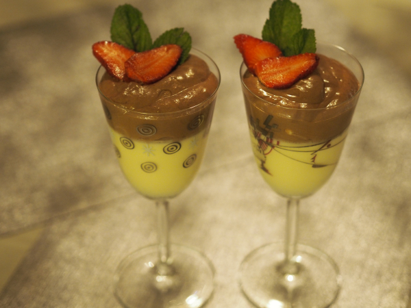 Bilde av pannacotta med sjokolademousse, klar til servering i høye glass. Bilde av pannacotta med sjokolademousse, klar til servering i høye glass.