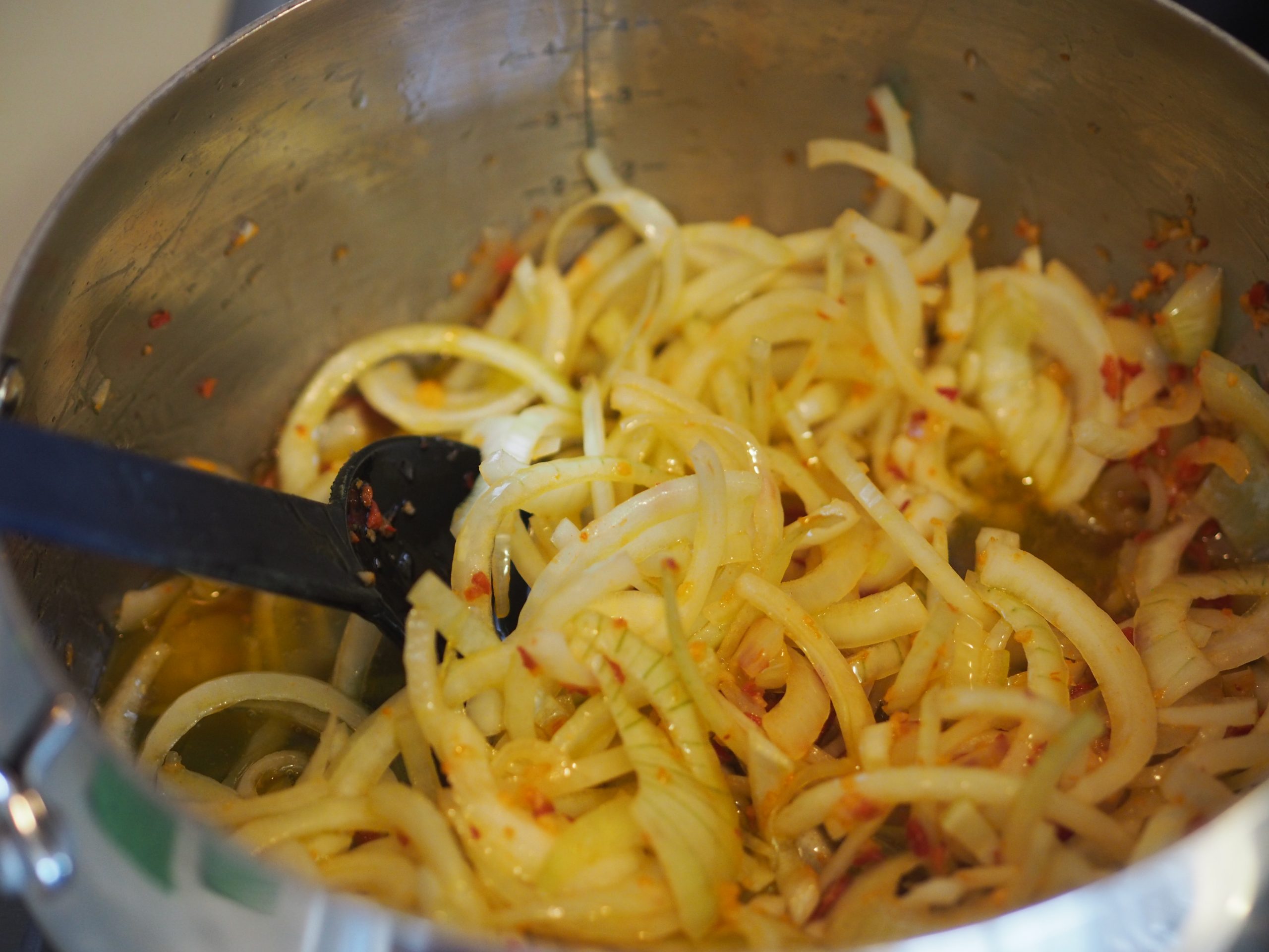 løk, hvitløk og chili surres blankt i en kjele til bacalao